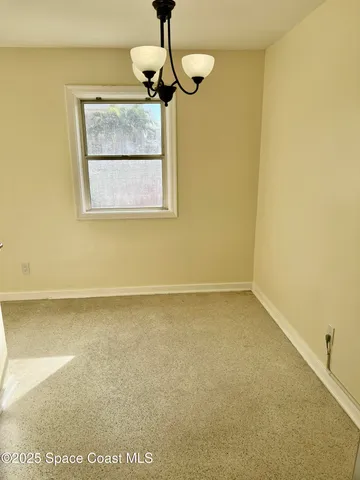 a view of a room with a wooden floor and a window