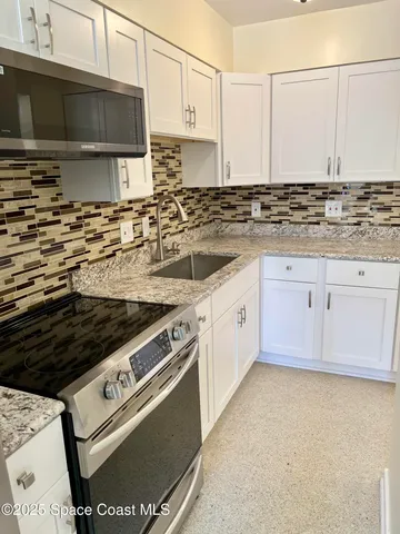 a kitchen with stainless steel appliances granite countertop a stove and a sink