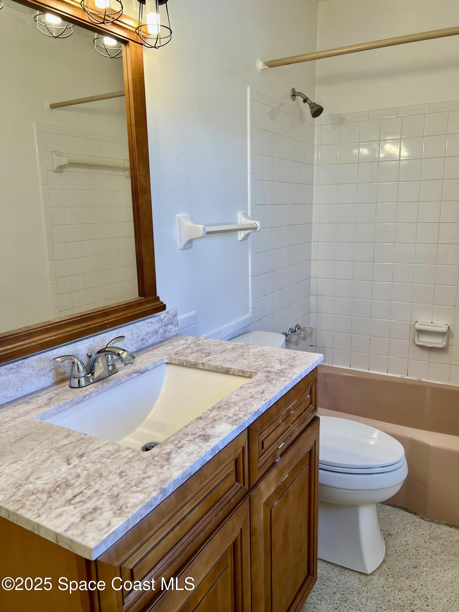 931 Palm Springs Boulevard, Unit B Indian Harbour Beach, FL 32937 - Photo 8 of 16 a bathroom with a sink a toilet and shower