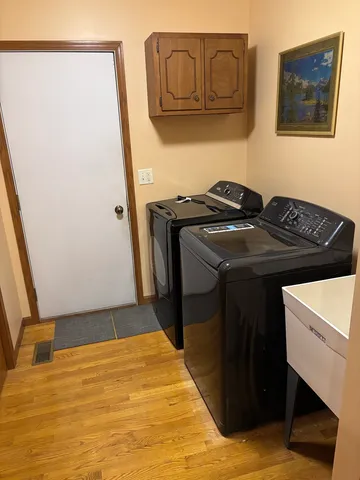 a large kitchen with stainless steel appliances granite countertop a stove and a view of living room