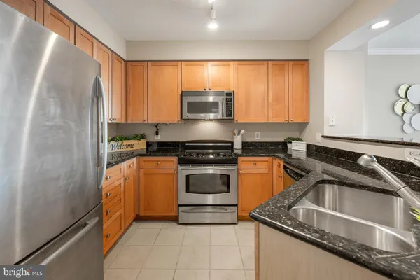 a kitchen with a sink and a stove top oven