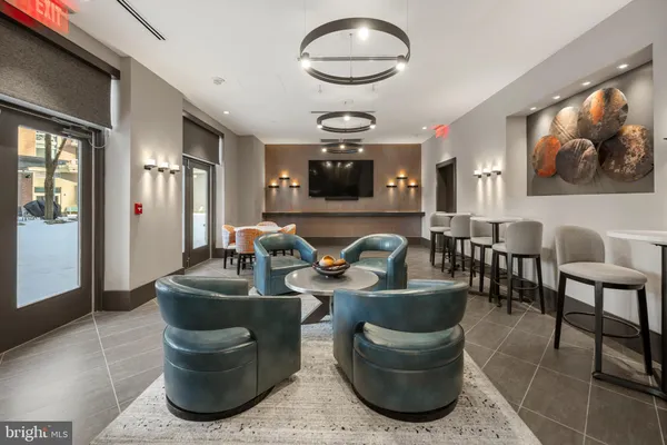 a living room with couches and kitchen view