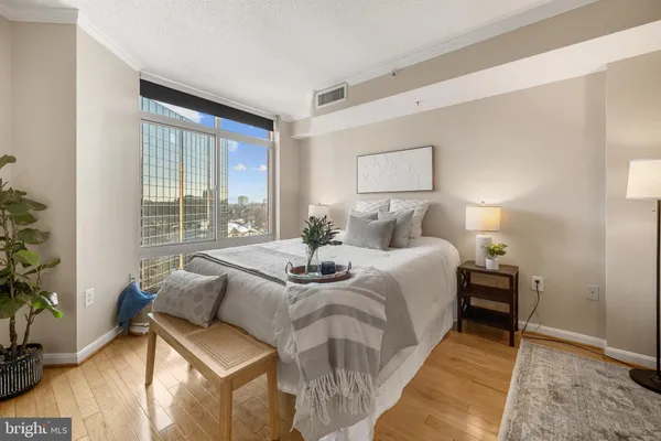 a bed room with a bed and a chair