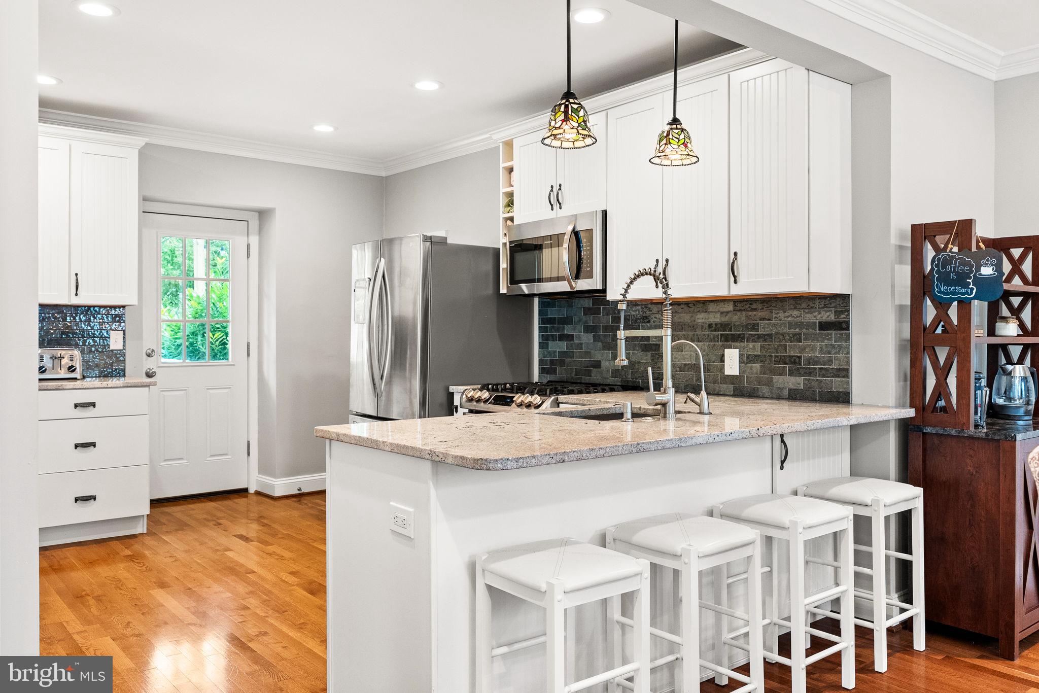 337 Old Lancaster Road Devon, PA 19333 - Photo 20 of 56 a kitchen with stainless steel appliances kitchen island granite countertop a stove and cabinets