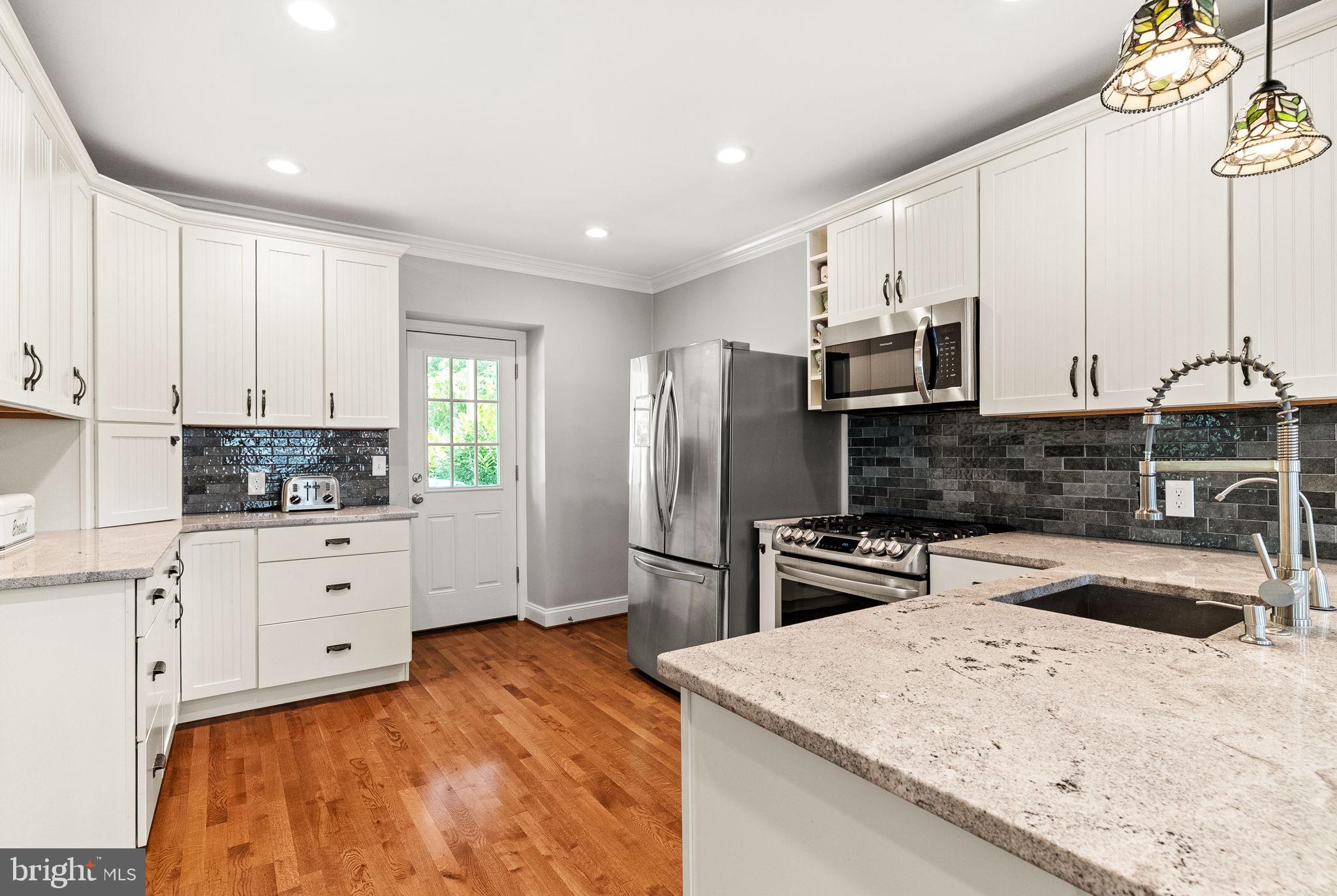 337 Old Lancaster Road Devon, PA 19333 - Photo 21 of 56 a kitchen with white cabinets and stainless steel appliances