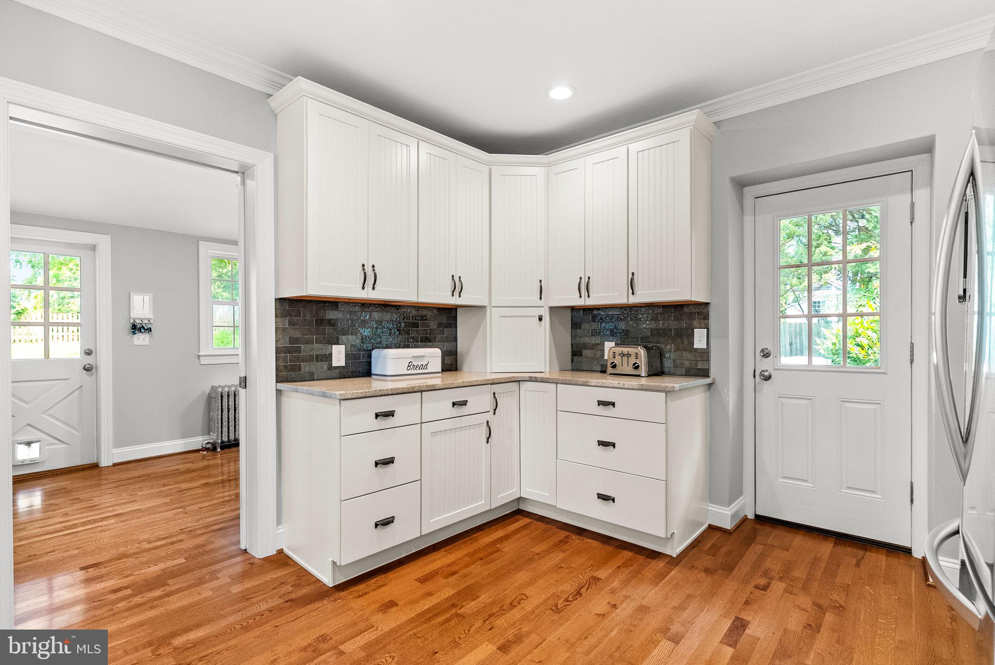 337 Old Lancaster Road Devon, PA 19333 - Photo 23 of 56 a kitchen with stainless steel appliances white cabinets and wooden floors
