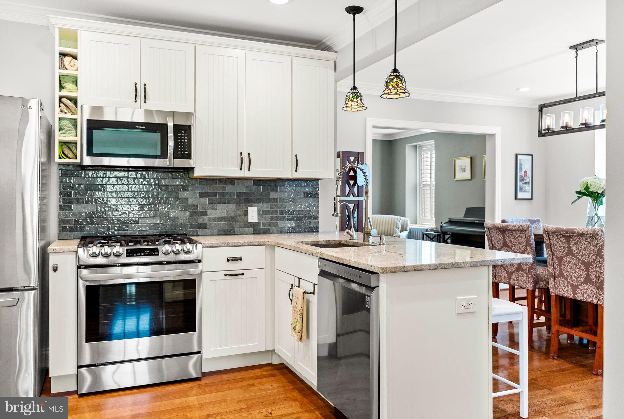 337 Old Lancaster Road Devon, PA 19333 - Photo 25 of 56 a kitchen with stainless steel appliances granite countertop a stove a sink and a microwave