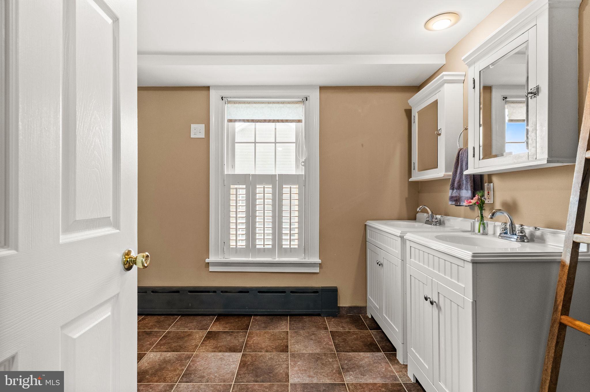 337 Old Lancaster Road Devon, PA 19333 - Photo 35 of 56 a bathroom with a granite countertop sink toilet and
