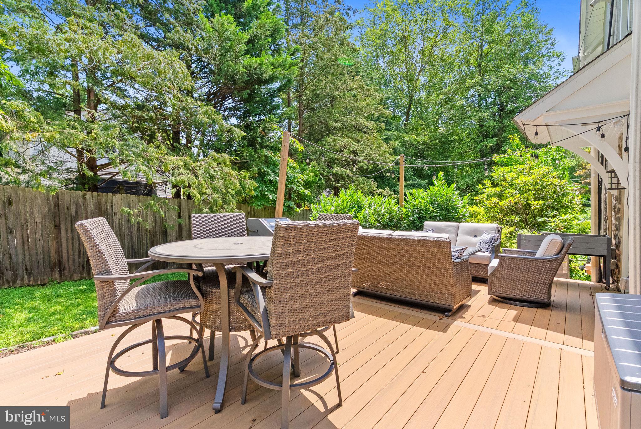 337 Old Lancaster Road Devon, PA 19333 - Photo 48 of 56 a view of a patio with table and chairs with wooden floor and fence