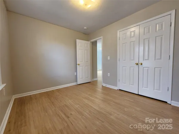 a view of an empty room and wooden floor