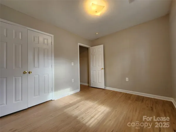 a view of an empty room and wooden floor
