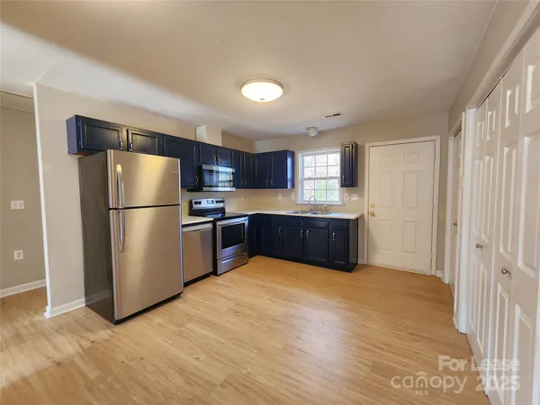 a kitchen with stainless steel appliances a refrigerator and a sink