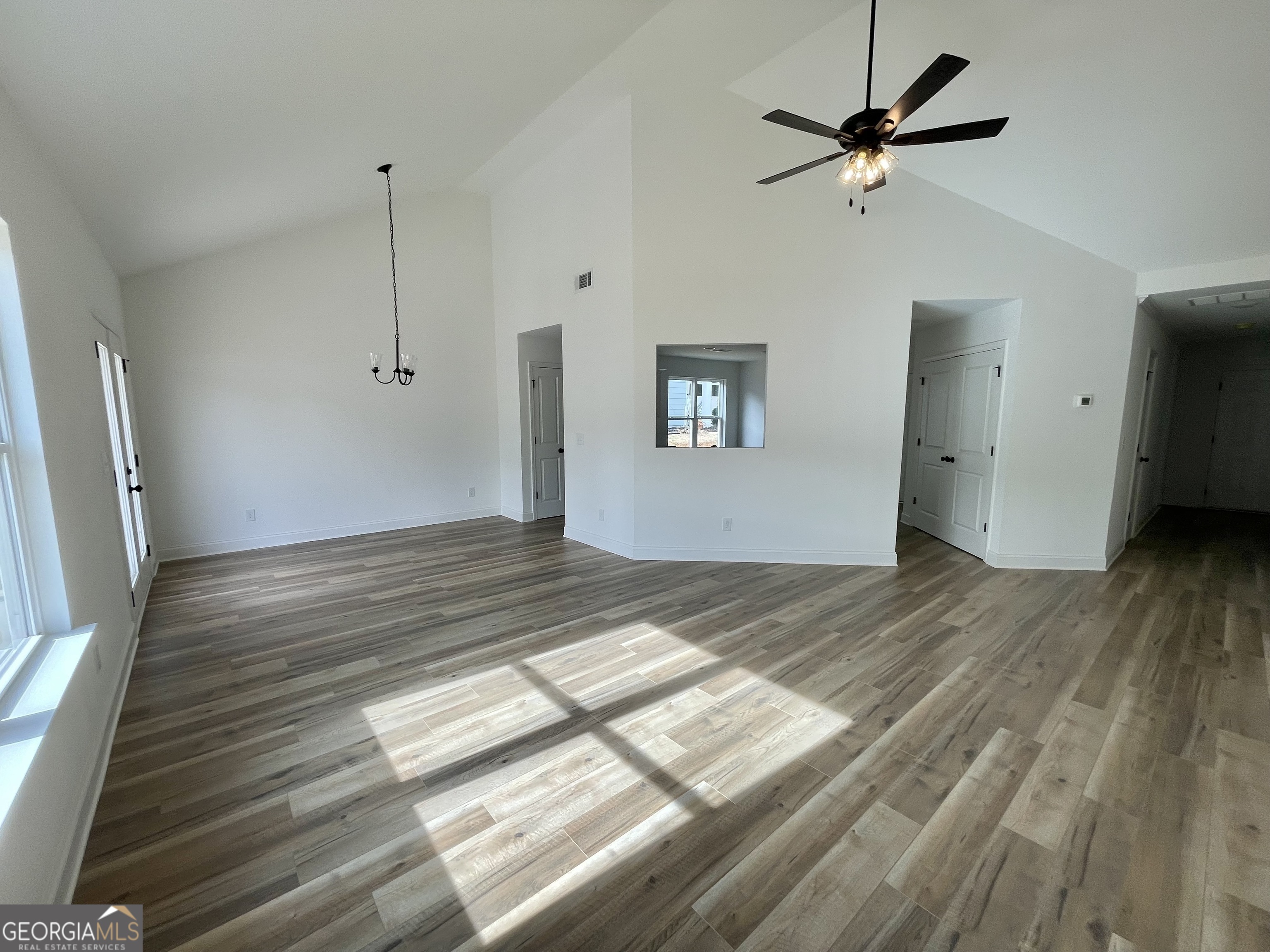 118 CHARLESTON Lane Milner, GA 30257 - Photo 11 of 21 a view of empty room with wooden floor and fan