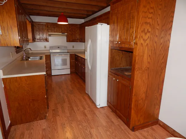 a kitchen with a stove and white cabinets