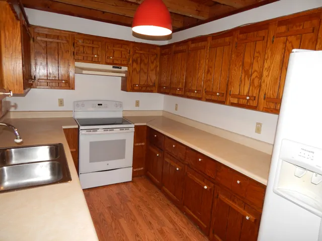 a kitchen with a sink cabinets and window