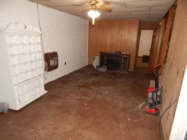 an empty room with closet and a chandelier fan