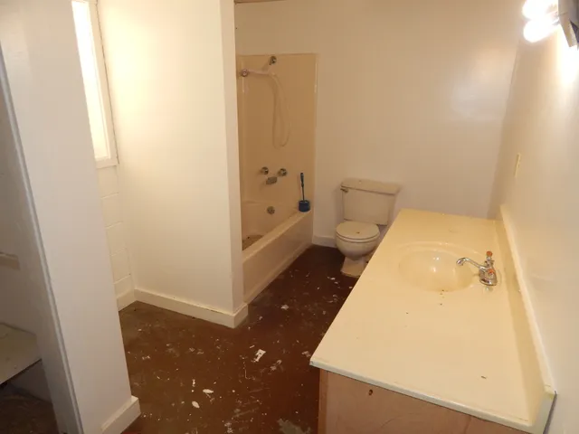 a room with a refrigerator and cabinets