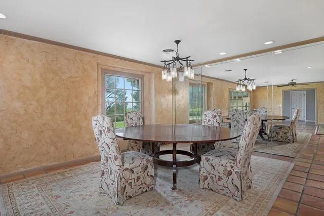 a view of a dining room with furniture and chandelier