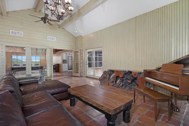 a living room with furniture and a chandelier