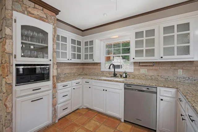 a kitchen with stainless steel appliances granite countertop a stove and a sink