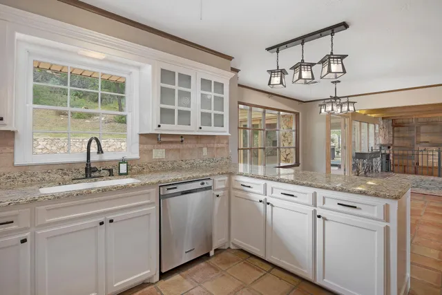 a kitchen with a sink stove and window