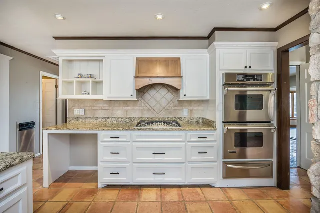 a kitchen with stainless steel appliances granite countertop a stove and a refrigerator