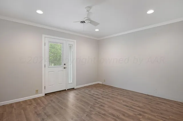 wooden floor in an empty room with a window