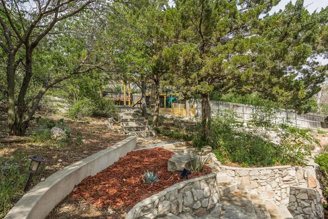 a view of a yard with wooden fence