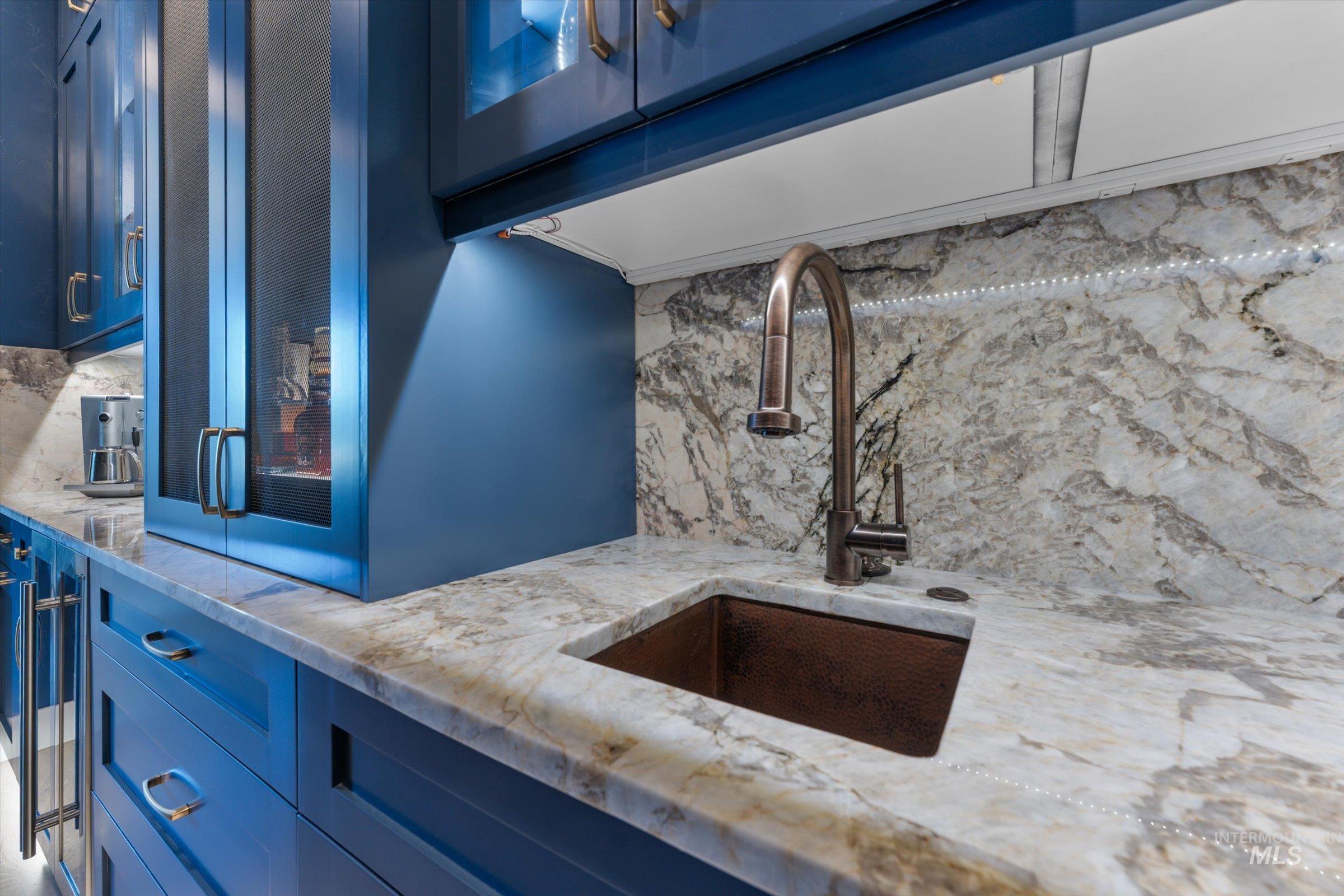 6585 South Pemberley Way Meridian, ID 83642 - Photo 19 of 43 Custom blue cabinetry with glass-front accents