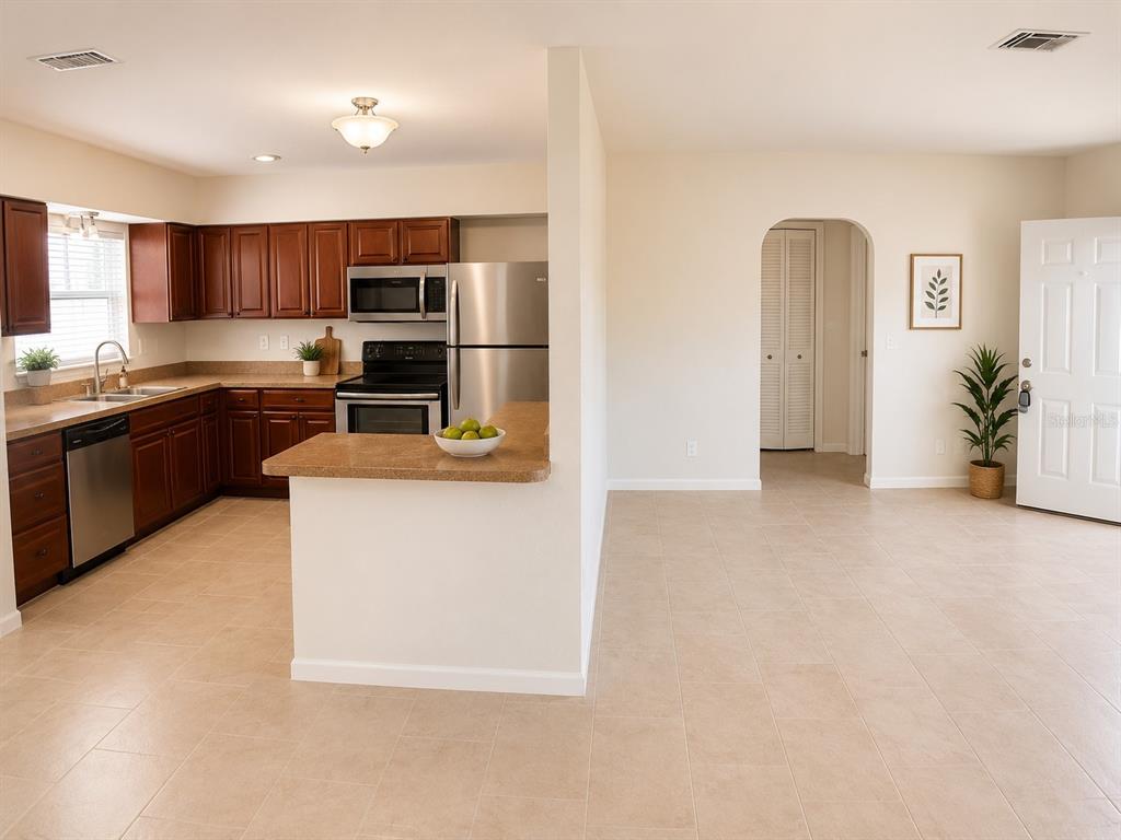 1559 Barry Road Clearwater, FL 33756 - Photo 4 of 20 a large kitchen with cabinets and stainless steel appliances