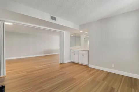 a view of an empty room and wooden floor