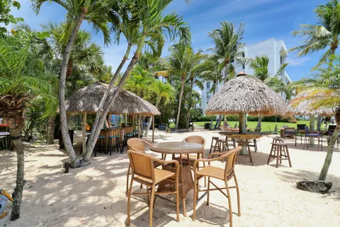 a view of a patio with a table and chairs under an umbrella