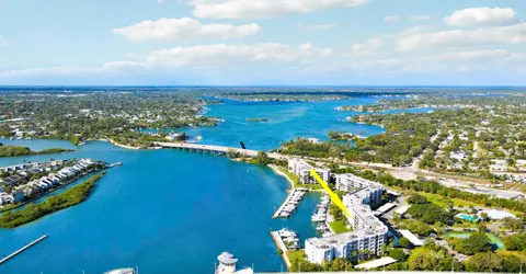 an aerial view of ocean and residential houses with outdoor space