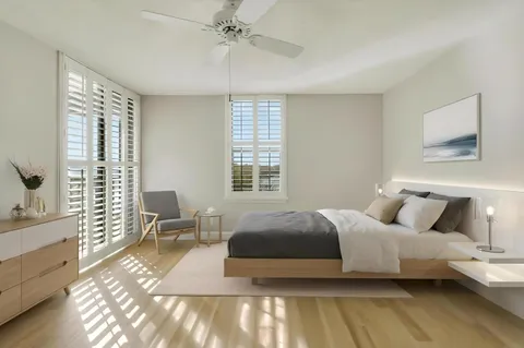 a bedroom with a bed and wooden floor
