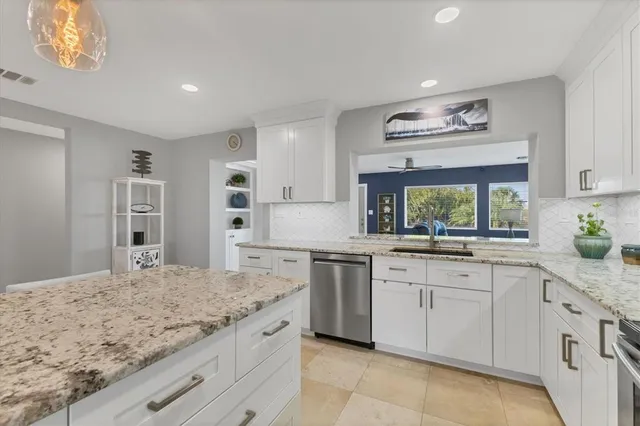 a bathroom with a granite countertop sink a toilet and mirror