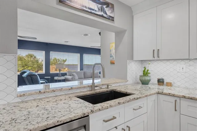 a bathroom with a granite countertop sink vanity mirror bathtub shower and a toilet