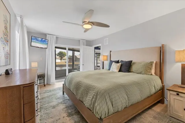 a spacious bedroom with a bed and a cabinet