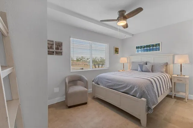 a bedroom with a bed couch and window