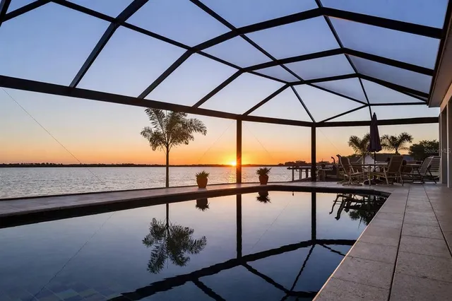 a living room with furniture kitchen view and a flat screen tv