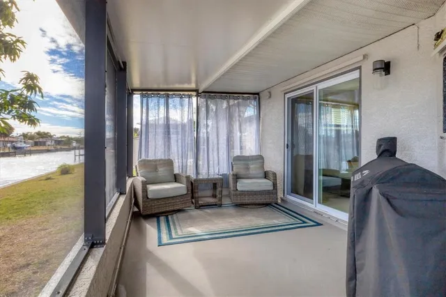 a balcony with table and chairs