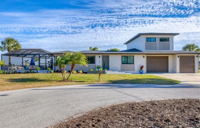 a view of a house with backyard and sitting area