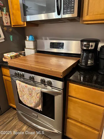 a stove top oven sitting inside of a kitchen