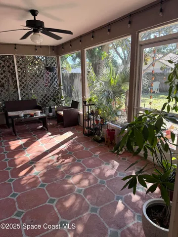 a living room filled with furniture and a potted plant