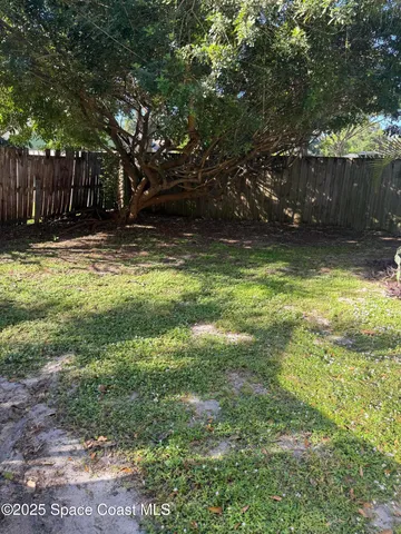a view of swimming pool with an outdoor space and wooden fence