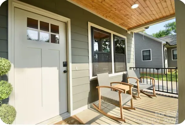 a balcony with table and chairs