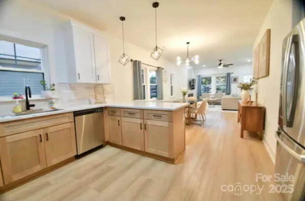 a kitchen with a sink appliances and cabinets