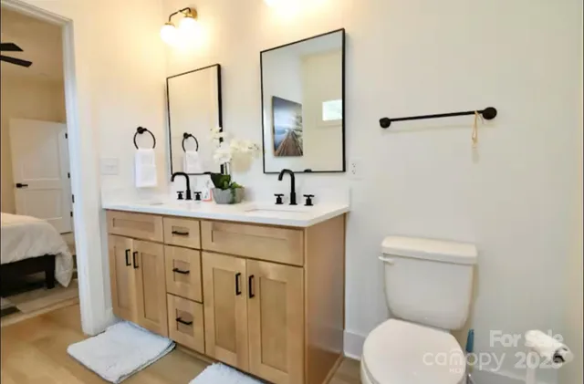 a bathroom with a toilet sink and mirror