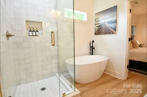 a bathroom with a white tub and shower