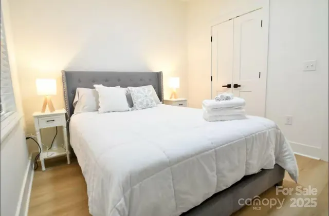 a bedroom with a bed and a night stand