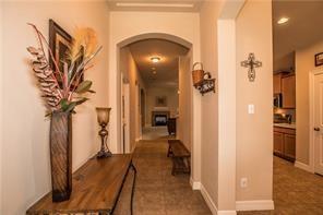 1409 Rosson Road Little Elm, TX 75068 - Photo 23 of 34 Arched entryway framing a long hallway with recessed lighting and crown molding